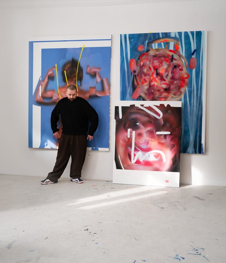 Artist Hadas Patryk standing in an art studio with large abstract oil paintings on white walls.