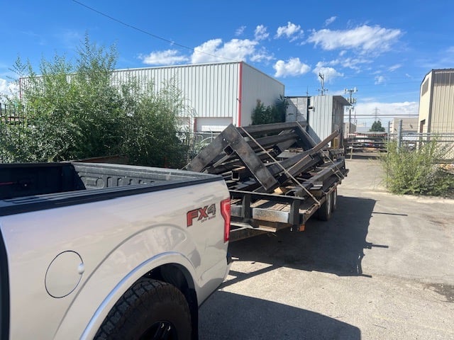 a truck with a trailer trailer loaded with a load of wood