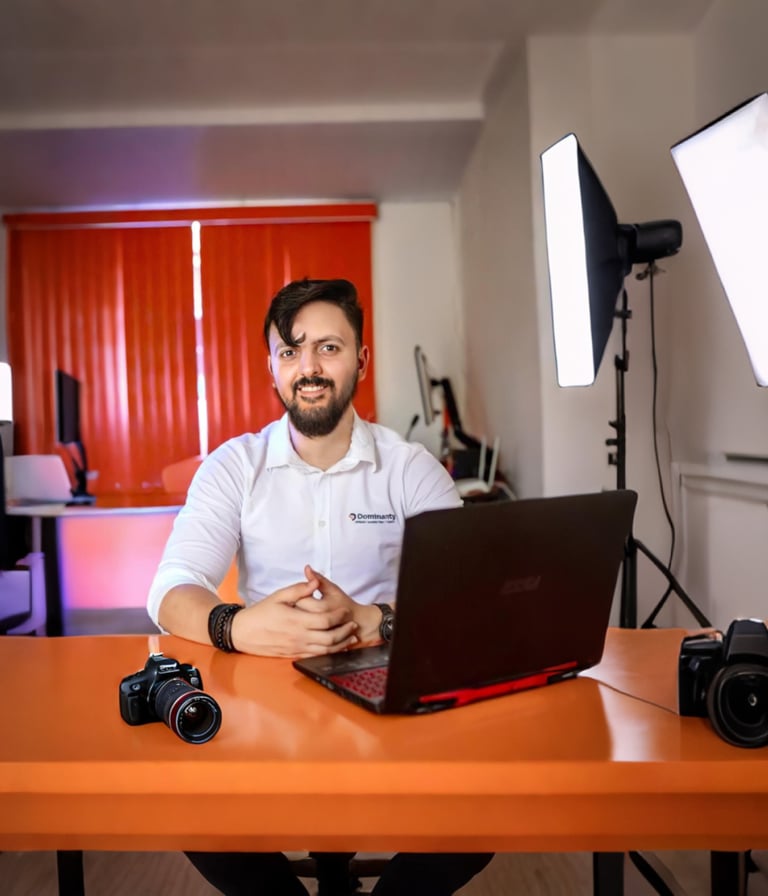 a man sitting at a table with a laptop computer