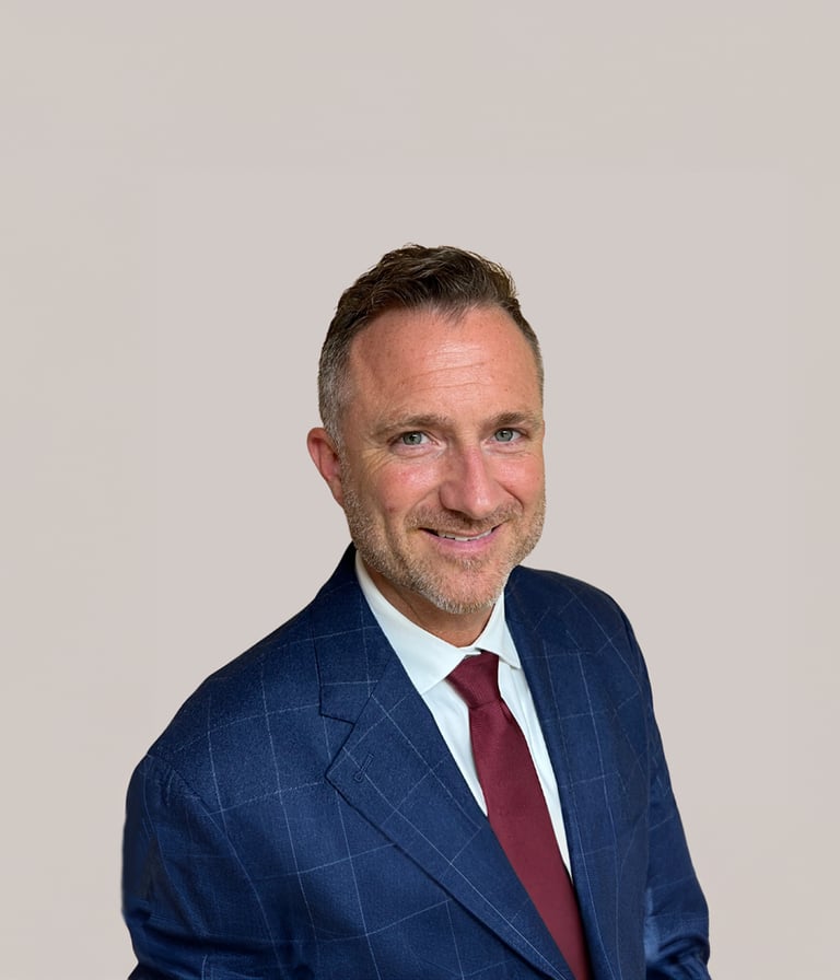 a man in a suit and tie smiling