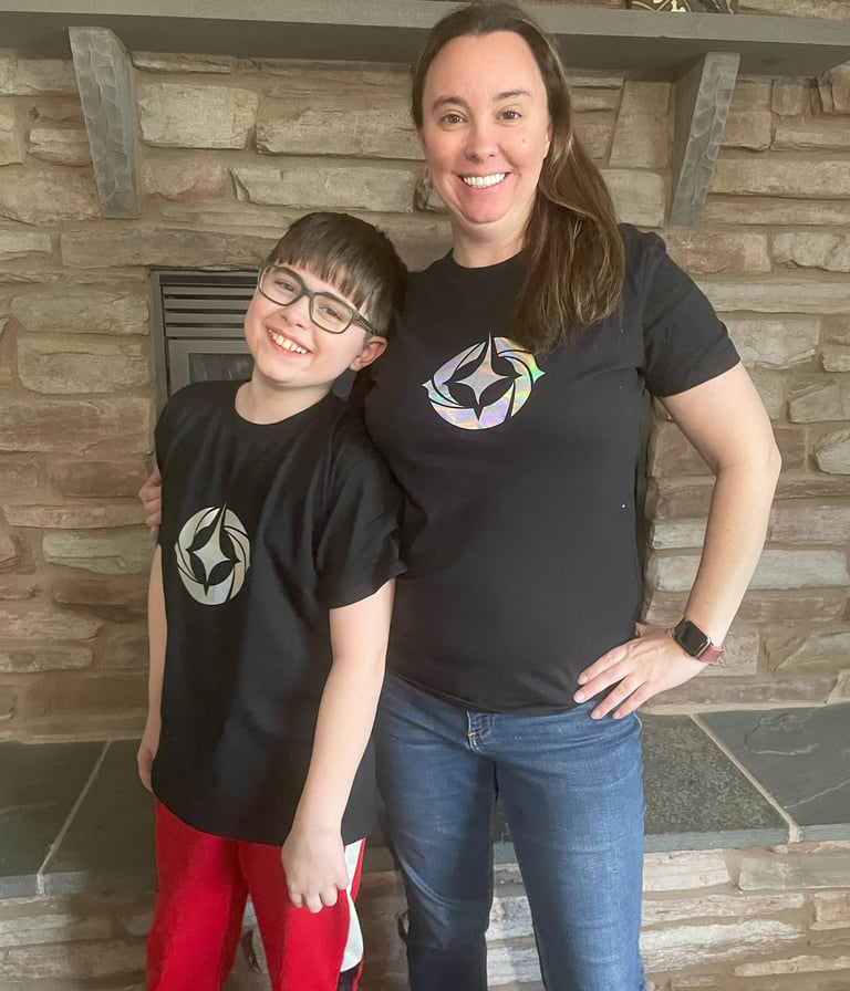 Erin and her son, Felix in Disney Lorcana shirts