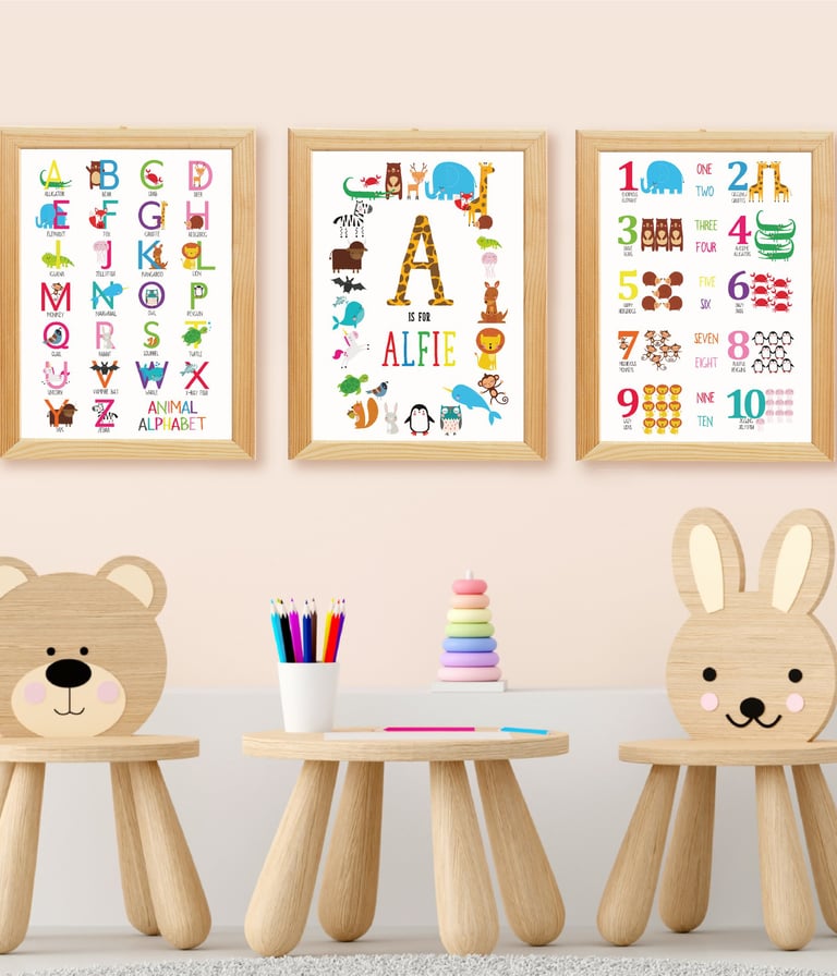 Set of three personalised alphabet and educational nursery prints displayed above a children's table
