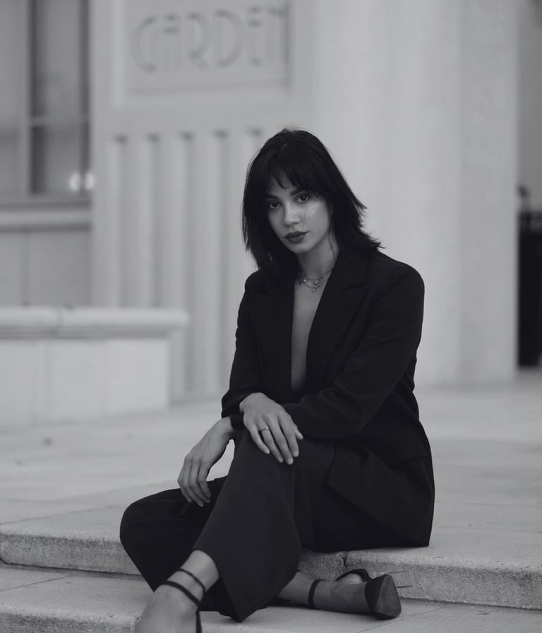 a well dressed woman with high standards wearing heels sitting outside a building
