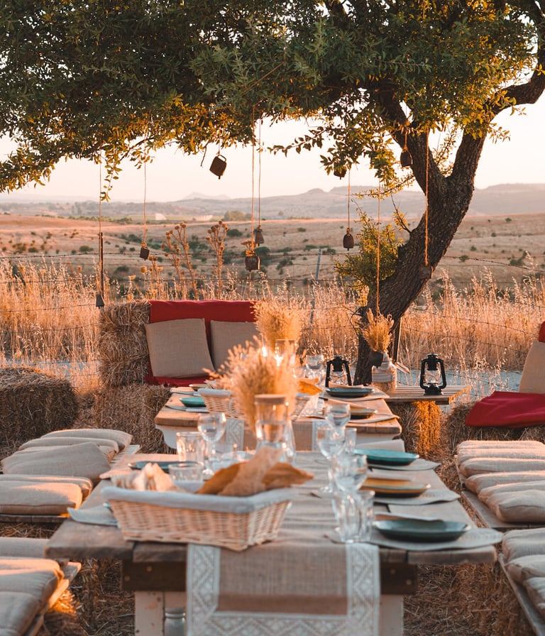 Outdoor dinner table with hay bale seats and wheat decorations in Ozieri, Sardinia