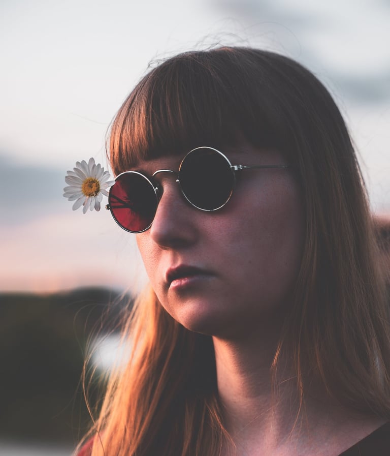 a woman with sunglasses on her face during sunset