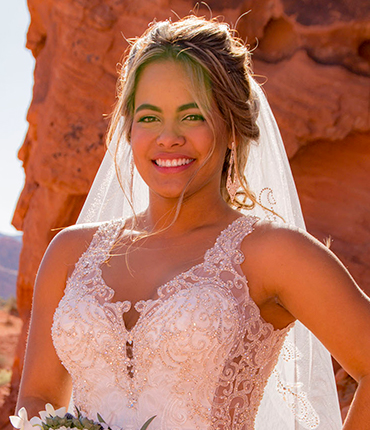 a woman in a wedding dress and veil with a veil on her head