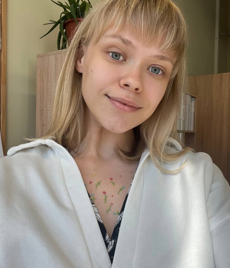 a woman with blonde hair and a white shirt