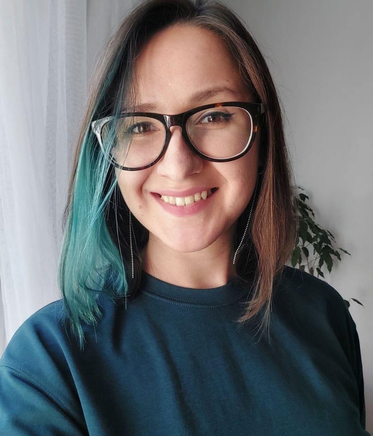 a woman with blue hair and glasses on her face