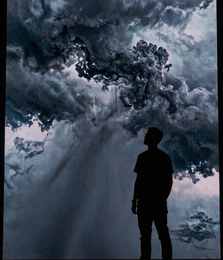 Silhouette of a creative director standing in front of a massive LED volume screen displaying a stormy sky in steel smoke and midnight slate. High impact, cinematic lighting.