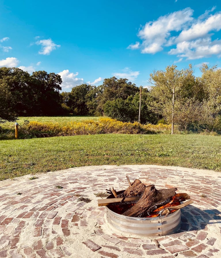 a fire pit in a circular brick patio