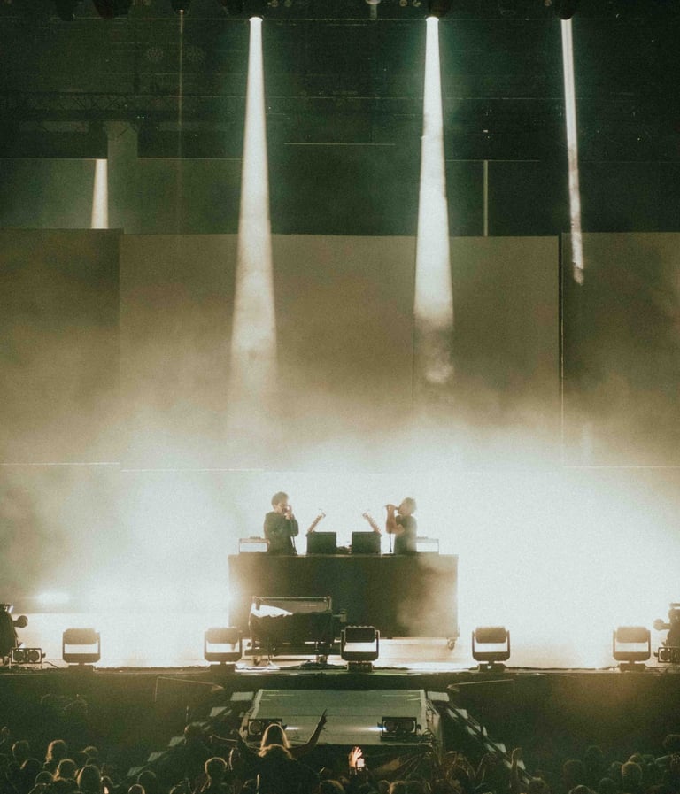 a man in a concert hall with a piano and a piano