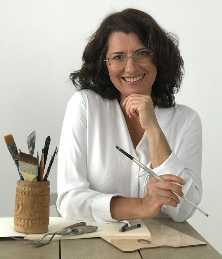 Mag Wilk a woman sitting at a table with a pencil and pencils