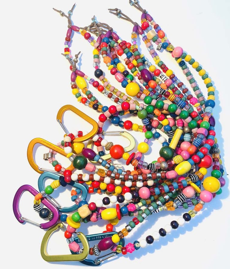 Handmade colorful beaded lanyards with metal carabiner clips for ID badges or keys.