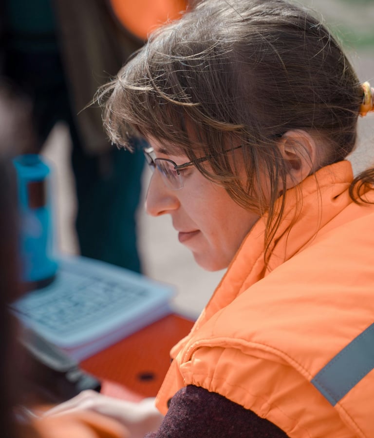 Staff member focused on details while work stacks up