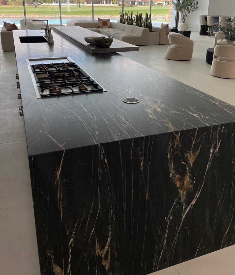 a kitchen island with black carerra marble counter top protected by top guard elite film 