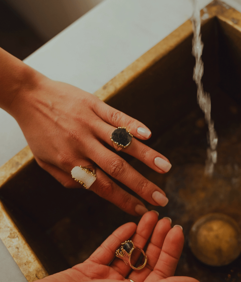 a woman's hands holding a ring with a ring on it