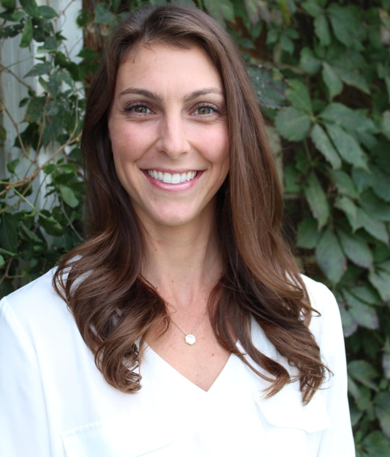 a smiling woman in a white shirt