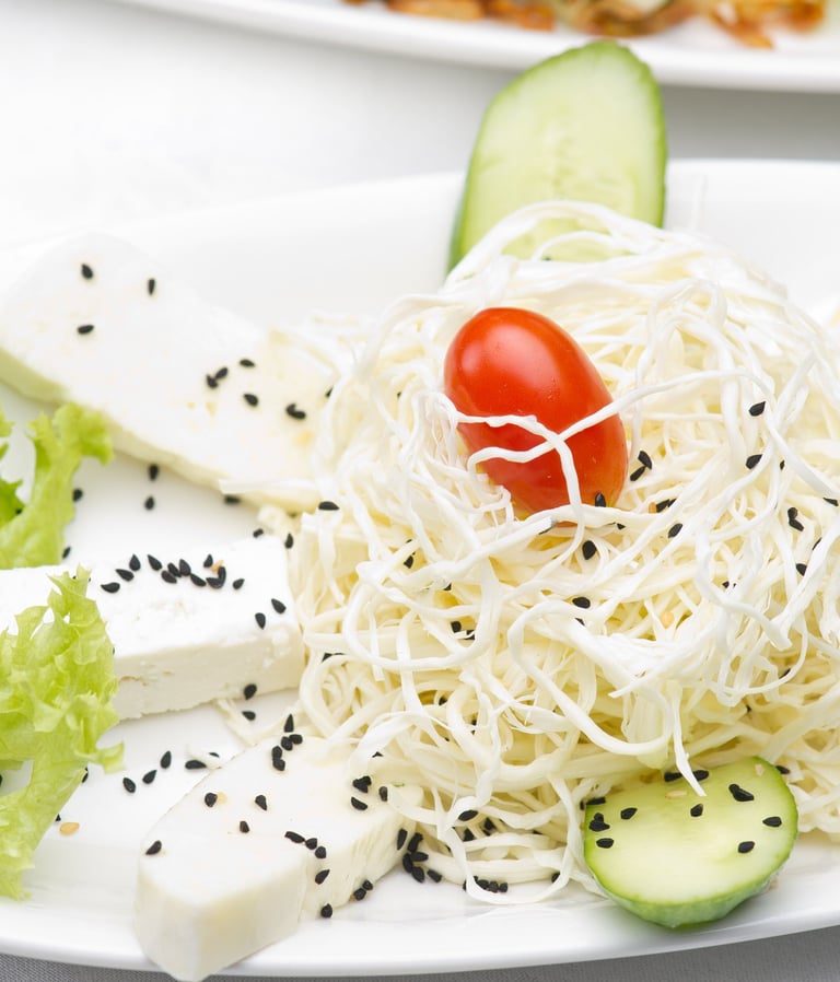 a plate of food with a tomato and cheese salad