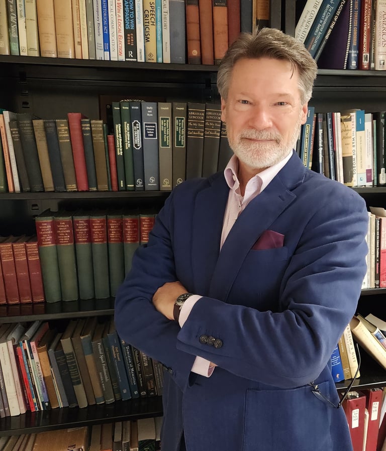 Picture of J. Andrew Kuypers bookcase in background