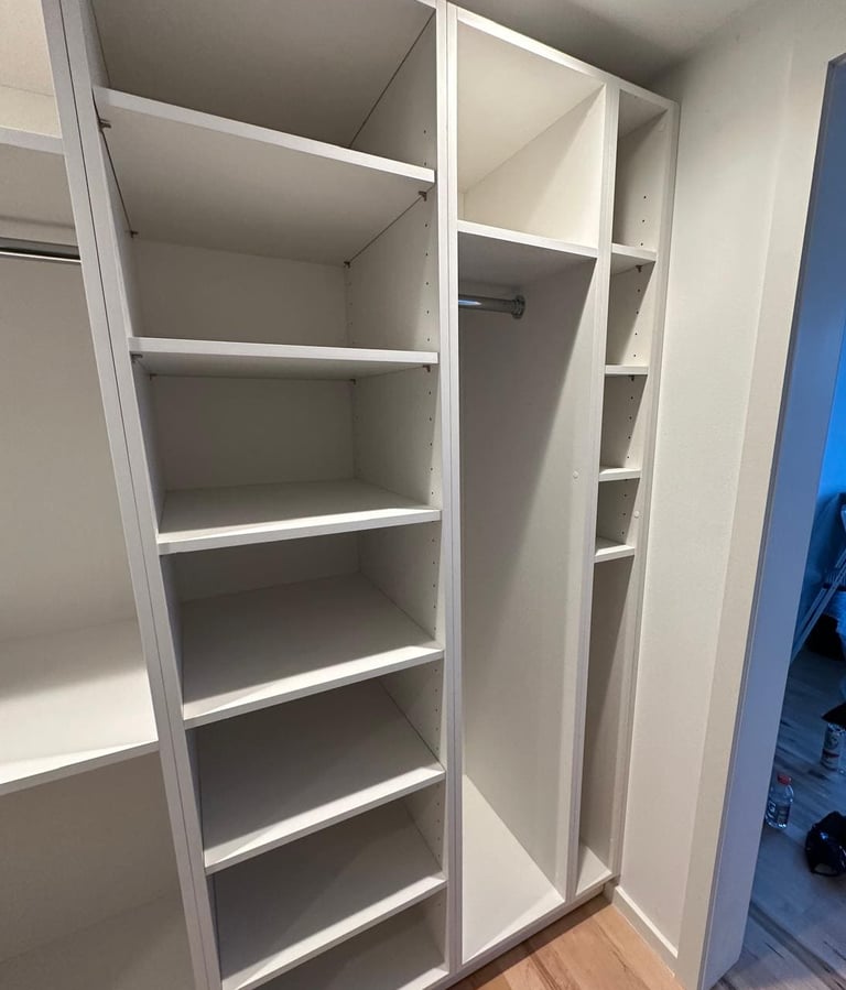 a closet with a closet door open and a closet door open