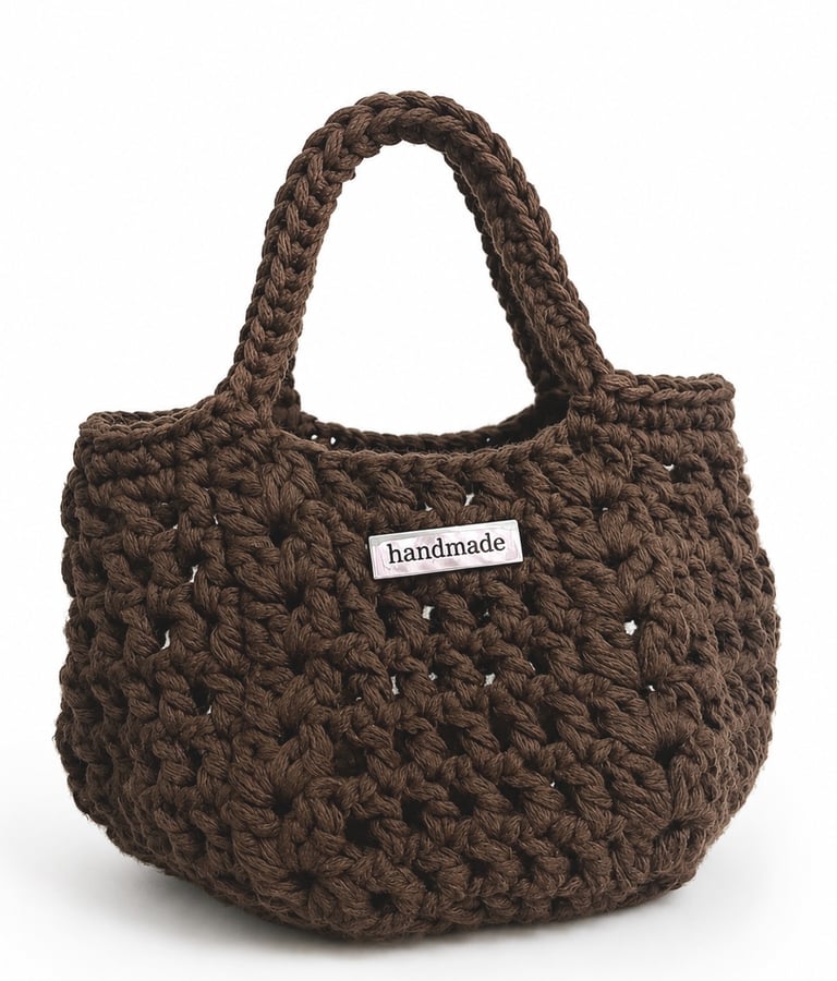 Custom metal logo label attached to a handmade crochet handbag