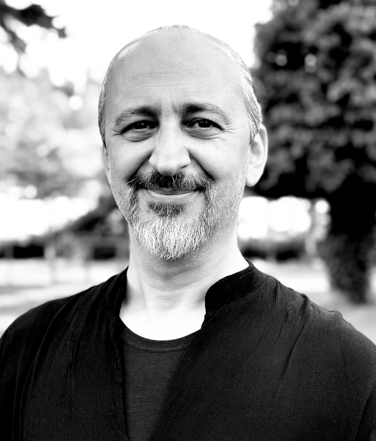 Ugur Tirpan Tai Ji Qi Gong instructor of WDP Turkey, smiling outdoors in black shirt