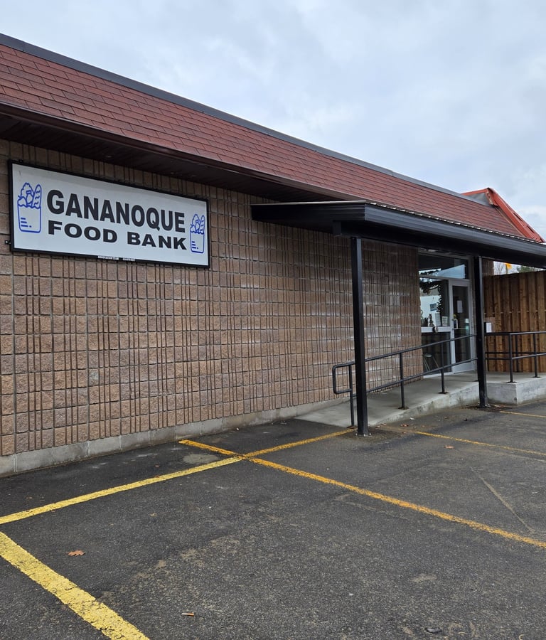 Exterior of the Gananoque Food Bank building with a brick facade and accessible ramp entry.