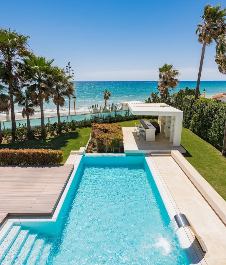 Beachfront pool and garden with outdoor bar pavilion