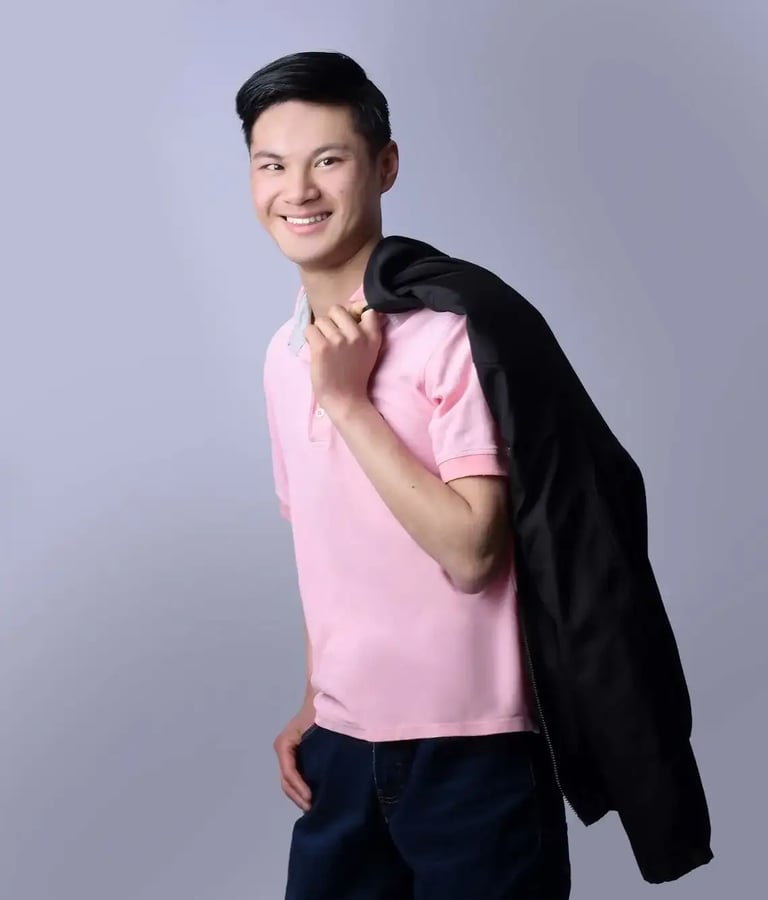 a man in a pink shirt and black jacket