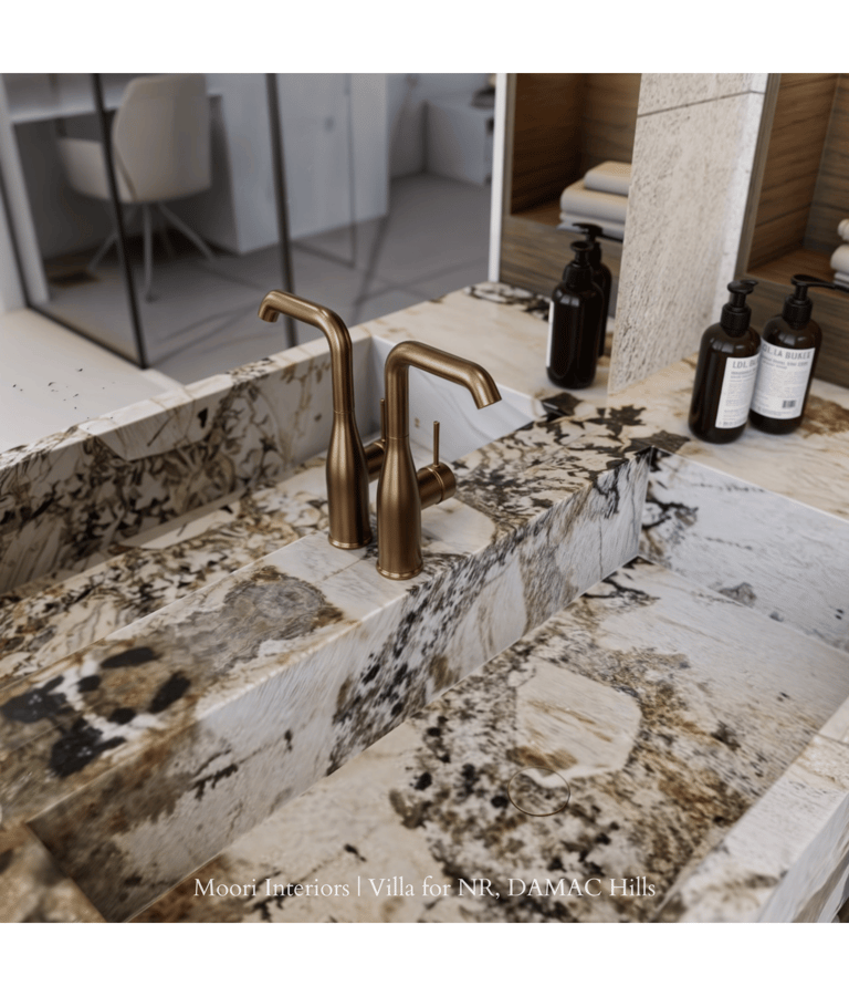 Elegant bathroom sink area showcasing a brass faucet and a distinctive marble countertop.