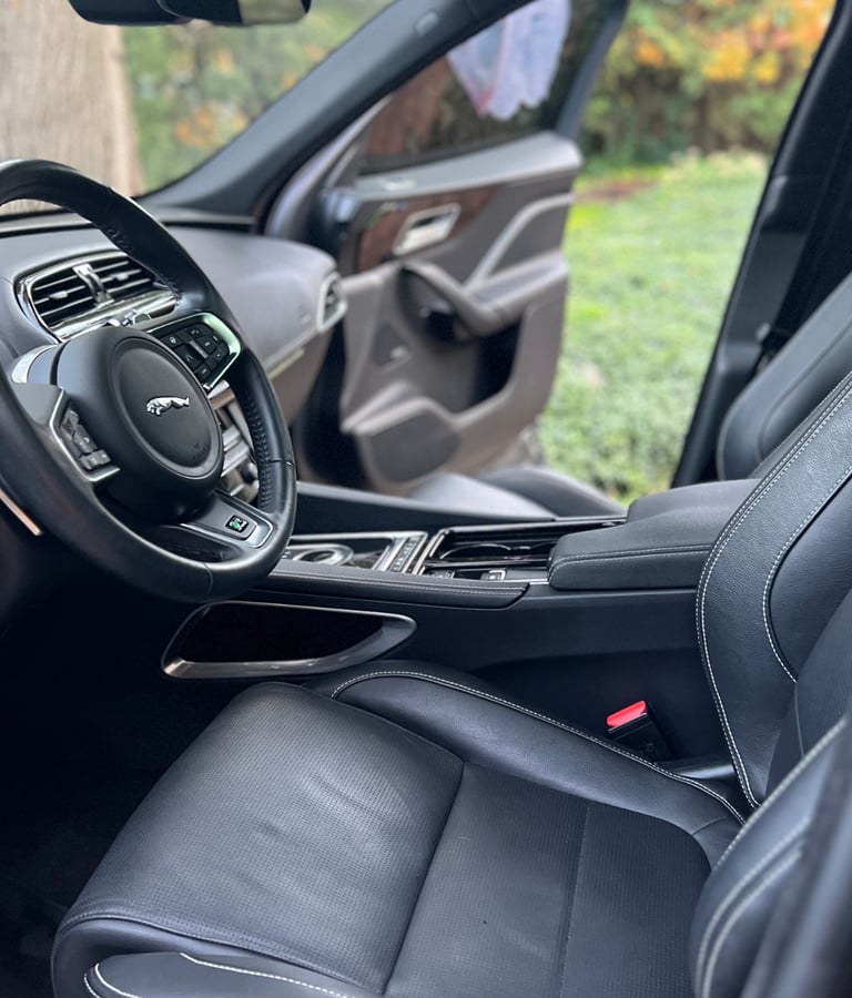 Sanitized SUV interior with clean cupholders and debris-free console