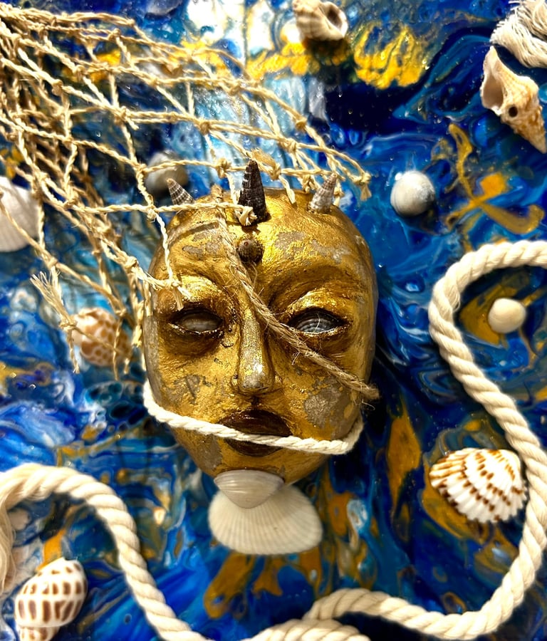 a gold mask with a gold face