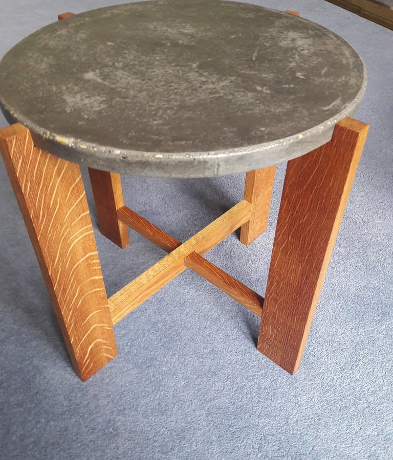 Coffee table made from 4 oak legs with cross pieces topped with a circular concrete top