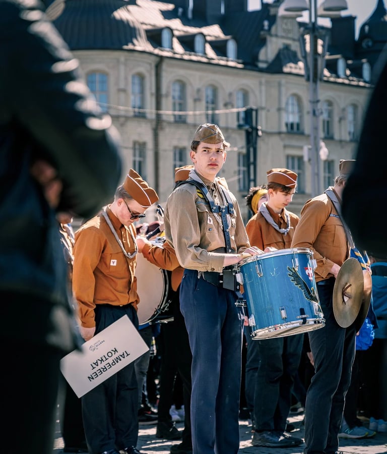 a man in a uniform is holding a drum and a drum