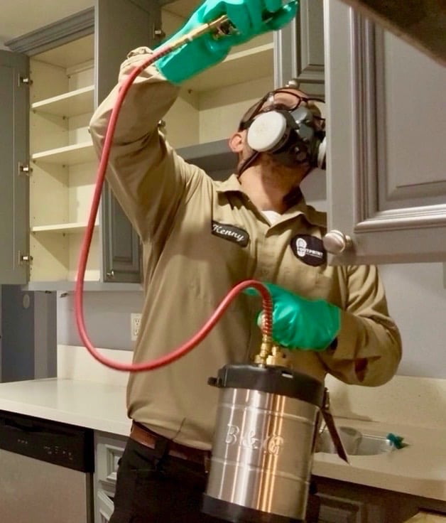 Exterminator on a Cockroach Treatment, inside a kitchen, in Menifee, Footprint Pest Management pest control near me