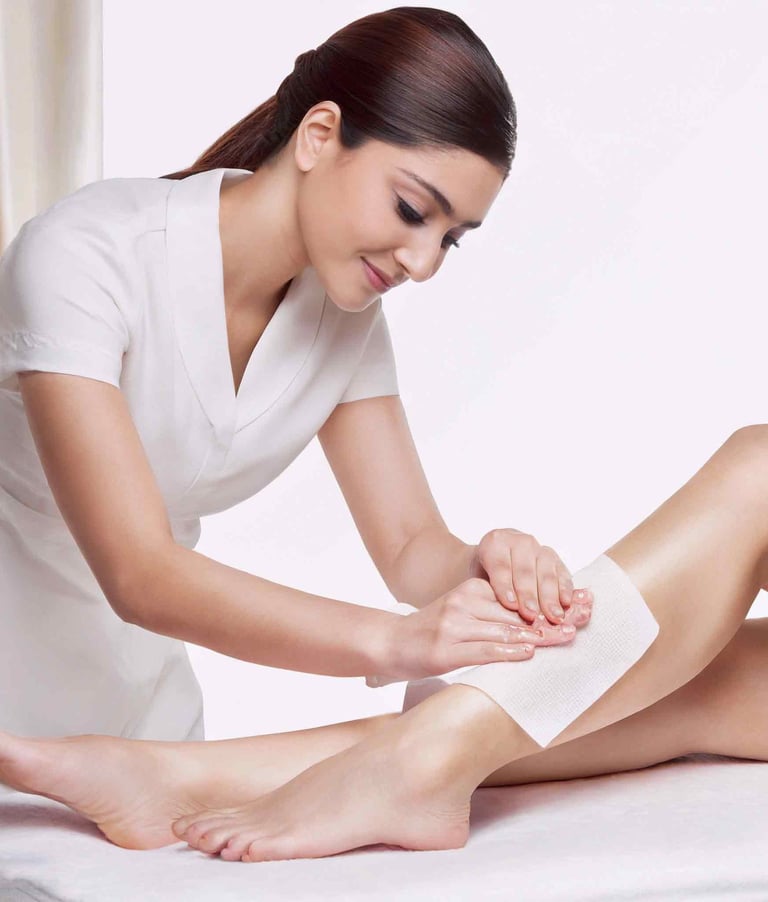a woman is getting her leg waxed by a wax strip