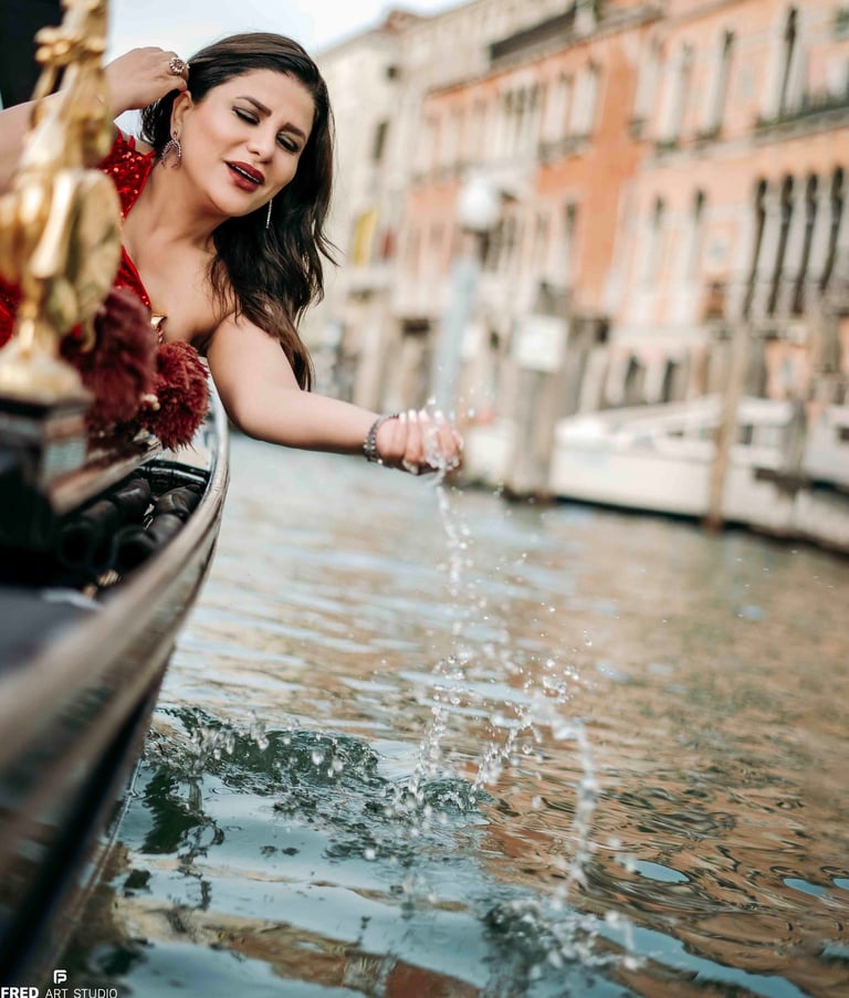 Woman in red dress on gondola in Venice