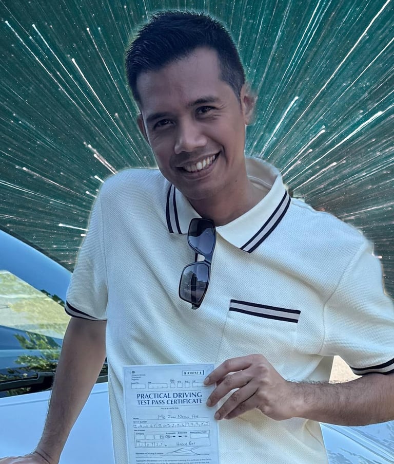 Man holding a certificate of passing a practical driving test in the UK