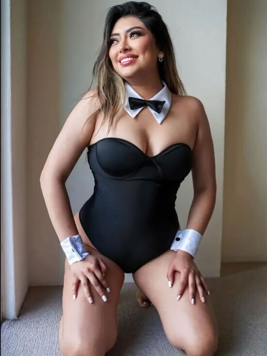 a woman in a black bathing suit and bow tie