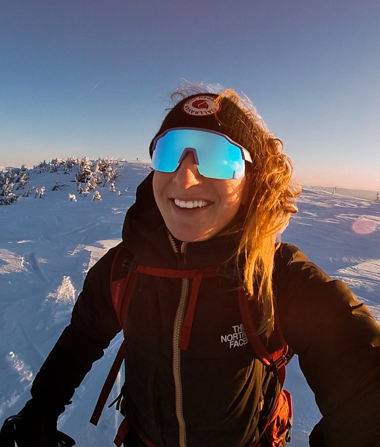 Mack Audino standing on a mountaintop, overlooking expansive landscapes, highlighting adventure trav
