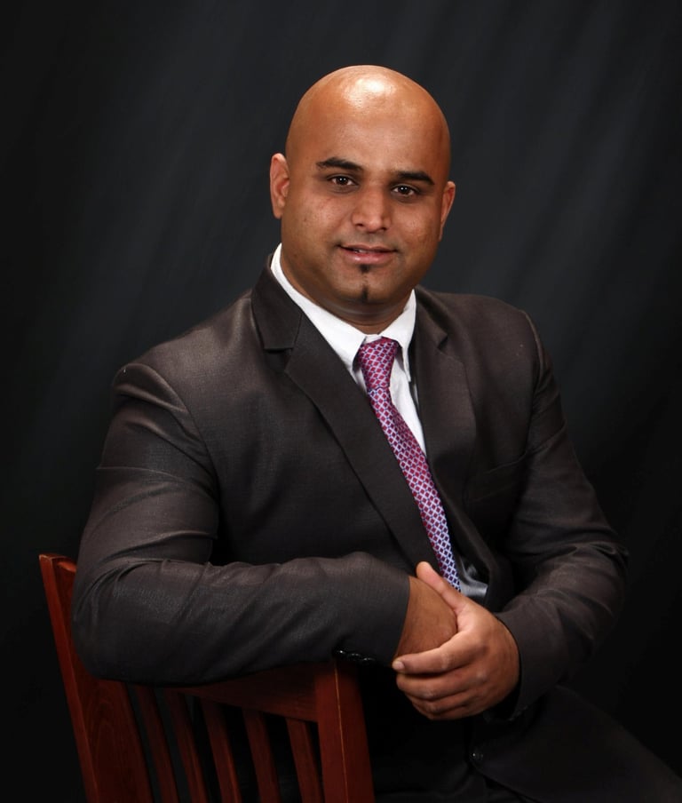 a man in a suit and tie sitting in a chair