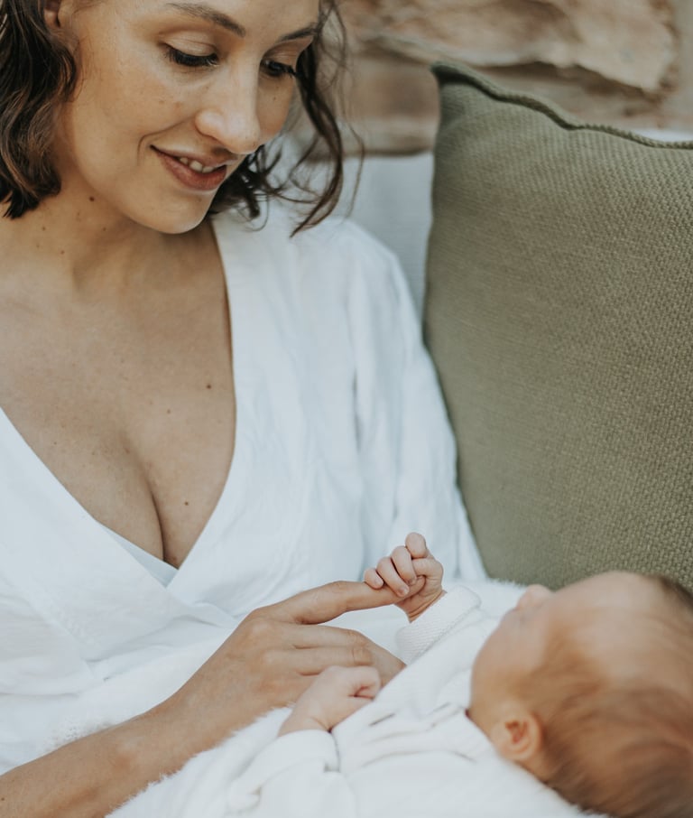 mom looking down at baby in a lifestyle newborn shoot