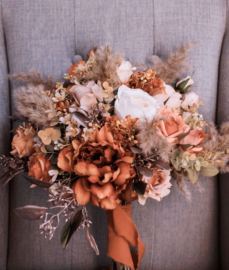 a bouquet of autumn flowers on a chair