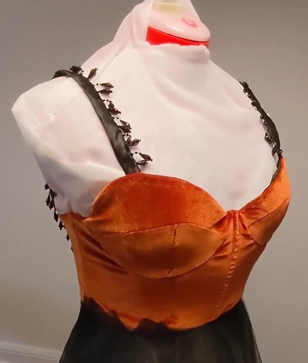 A burnt orange velvet sweetheart neckline dress with beaded black straps