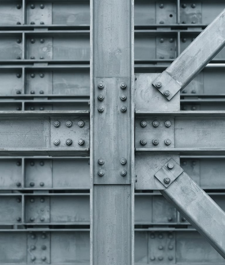 Orthographic close-up of a structural steel joint, desaturated cool grey tones, crisp overcast daylight, minimalist architectural photography, sharp focus