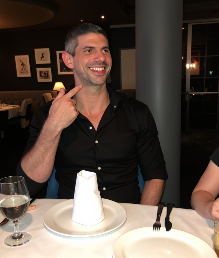 Candid personal photo of Adam Bair laughing at a dinner with friends in Miami.
