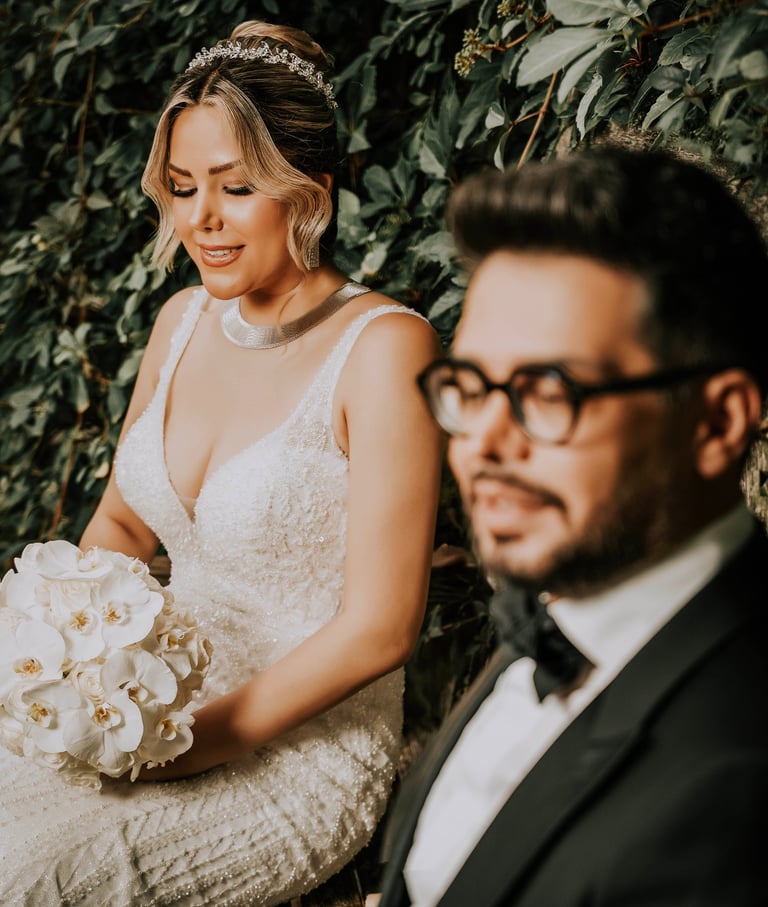 ride holding white orchids beside groom in black tuxedo, captured by Fred Art Studio