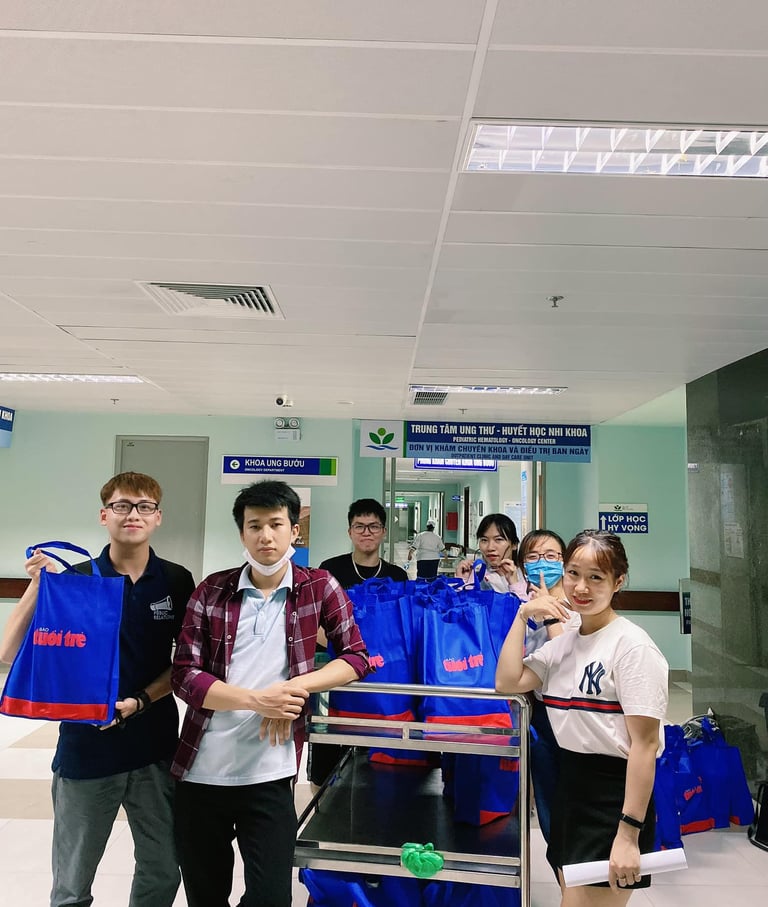 a group of people standing around a carton