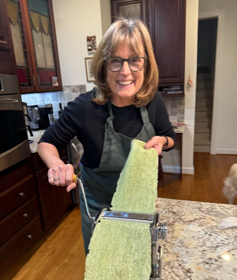 Class participant hand rolling spinach pasta noodle