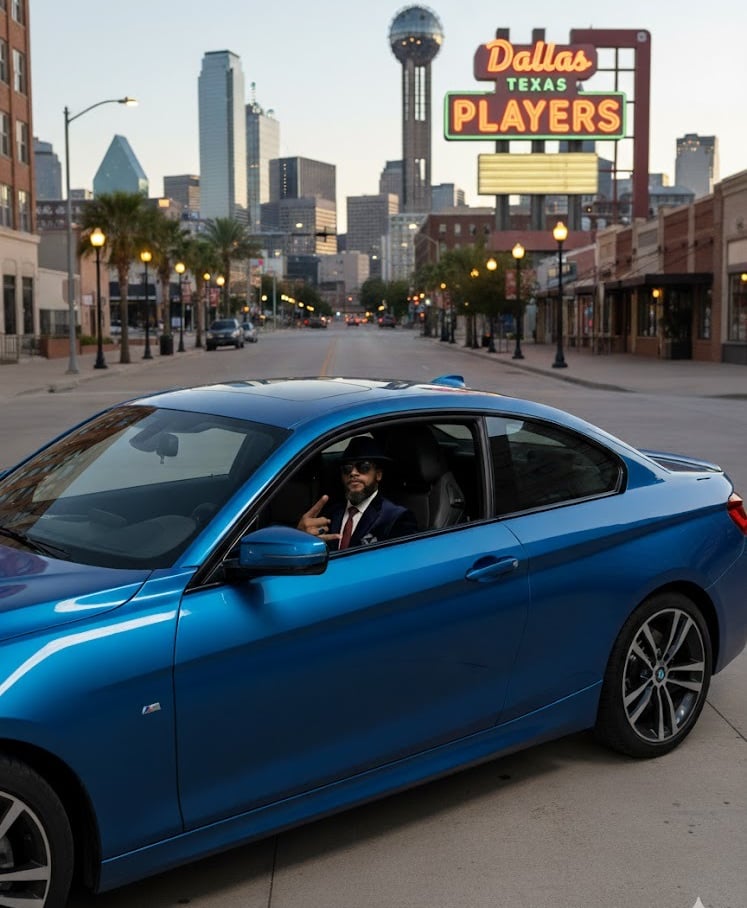 a man driving a blue bmw car down a city street